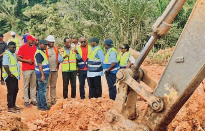Roads and Highways Minister Kwame Agbodza receiving briefing from the contractor, DWAWILL Ltd
