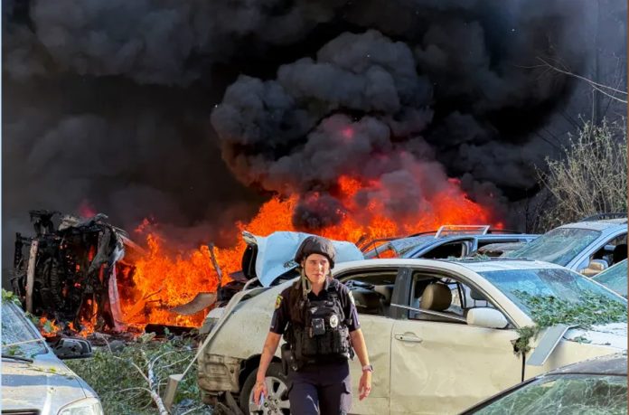 A police officer surveys the site of a Russian attack on residential area
