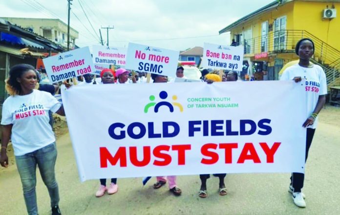 Demonstrators displaying the placards