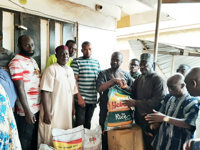 Nana Agyei Baffour Awuah presenting food items to victims