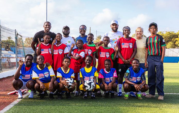 Female student-athletes pose with facilitators and school authorities at the event.
