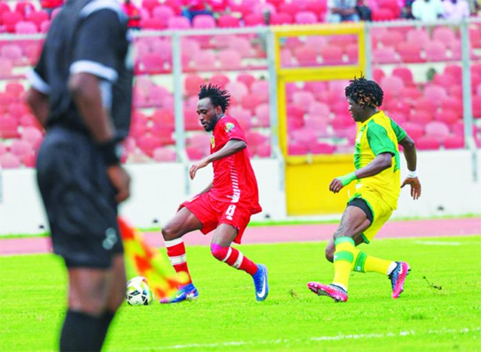Kotoko and Aduana player in a battle for the ball