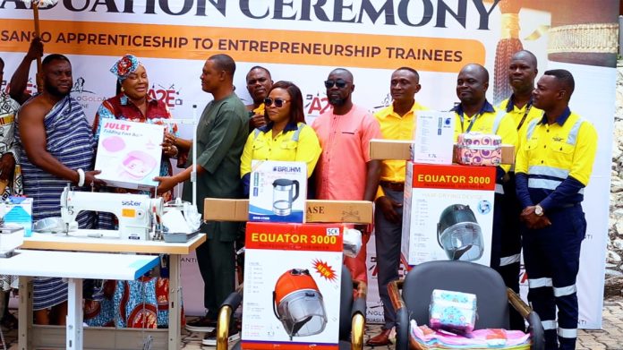 Local assemblyman Justice Ofori Amanfo receiving the equipment on behalf of ladies from Nana Osei Kwame (left) as stakeholders look on