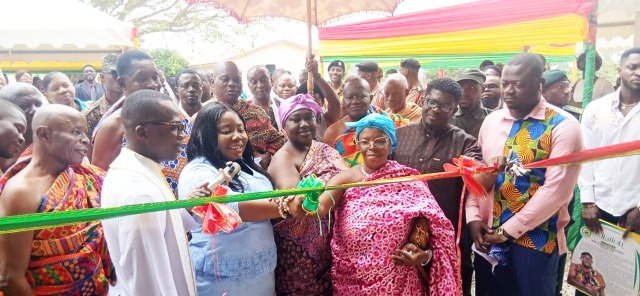 The DCE (3rd left) being assisted by traditional authorities to officially open the school