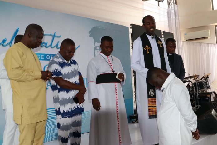 The Municipal Chief Executive (MCE) for Abuakwa South in the Eastern Region, Nana Adu Sarpong Addo Aikens Jnr. seek the protection of God as he recieves prayers from some men of God