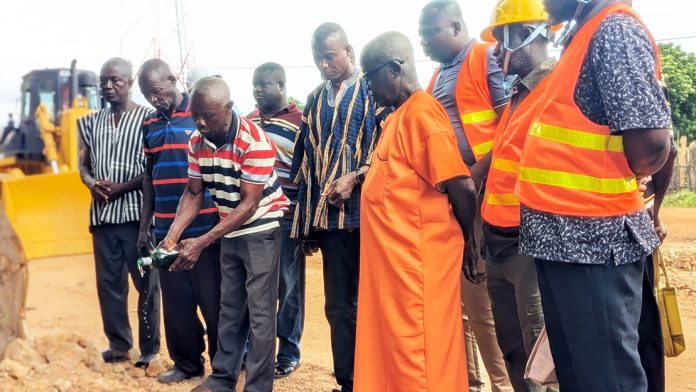 Traditional leaders pouring libation foro commencement of work on the road