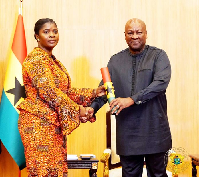 President Mahama presenting an instrument of appointment to Madam Emelia Afi Agbenyo as new deputy Chairperson for the EC
