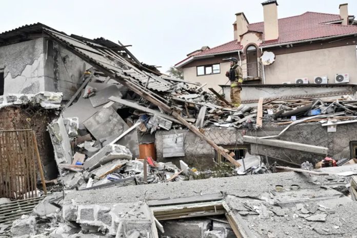 Rescuers work at the site of a house damaged by a Russian drone strike in Zaporizhzhia, Ukraine